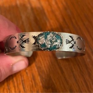 Silver Bracelet with turquoise colored jewel.